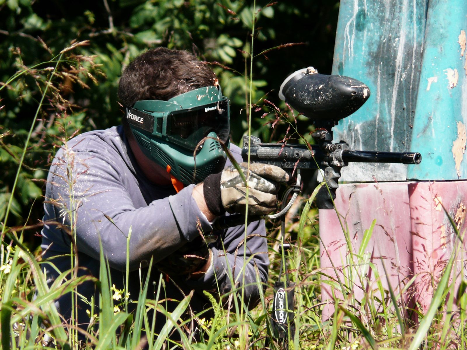 Player aiming from behind cover at a paintball game near Rexburg